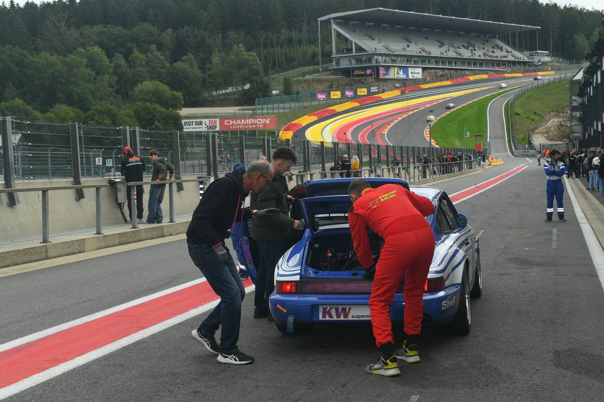 Die Aimpoint-Crew arbeitet in der Boxengasse von Spa am geöffneten Heck des Porsche 964